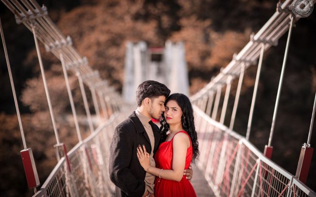 Gaurav & Neha laughing and walking on a bridge in Rishikesh during their pre-wedding shoot, captured by Wedding Fever Films, best pre-wedding photographers in Rishikesh.
