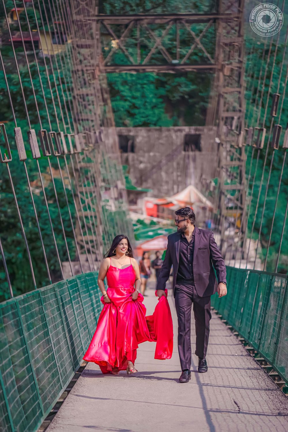Couple walking hand in hand on suspension bridge in Rishikesh.